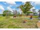 Expansive backyard featuring lush lawn, mature trees and decorative landscaping creating serene outdoor space at 1156 Lemon Bay Dr, Venice, FL 34293