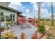 Charming backyard patio features decorative fence, lush landscaping, and outdoor dining area at 1156 Lemon Bay Dr, Venice, FL 34293
