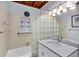 Bathroom with a tub shower and a glass block partition at 1156 Lemon Bay Dr, Venice, FL 34293