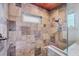 This tiled shower features glass doors and a shower niche at 1156 Lemon Bay Dr, Venice, FL 34293