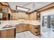 Well-lit kitchen features wooden cabinets, countertops, and modern appliances at 1156 Lemon Bay Dr, Venice, FL 34293