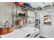 Functional laundry room features white washer/dryer units, shelving, and access door to exterior at 1156 Lemon Bay Dr, Venice, FL 34293