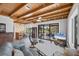 Relaxing living room features a wooden ceiling, tiled floors, and access to an outdoor patio at 1156 Lemon Bay Dr, Venice, FL 34293