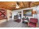 Cozy living room features a rustic wooden ceiling, tiled floors, and stylish furnishings at 1156 Lemon Bay Dr, Venice, FL 34293