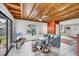 Comfortable living room boasts a wooden ceiling, tiled floors, and a view of the backyard at 1156 Lemon Bay Dr, Venice, FL 34293