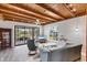 Bright living room with a wooden ceiling, tiled floors, and sliding doors to the backyard at 1156 Lemon Bay Dr, Venice, FL 34293