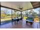 Spacious screened patio with seating and dining area, offering serene backyard views at 1156 Lemon Bay Dr, Venice, FL 34293