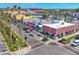 Street view showcases a mix of commercial buildings with inviting storefronts and vibrant red awnings and palm trees at 1156 Lemon Bay Dr, Venice, FL 34293