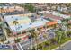 Street-level view of charming storefronts along a palm-lined avenue, with cars parked along the street at 1156 Lemon Bay Dr, Venice, FL 34293
