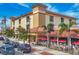 Inviting building with outdoor seating and a red tile roof, complemented by lush palm trees and a well-maintained sidewalk at 1156 Lemon Bay Dr, Venice, FL 34293
