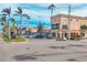 An appealing street corner view, with lovely buildings, pedestrian walkways, and lush palm trees lining the avenue at 1156 Lemon Bay Dr, Venice, FL 34293