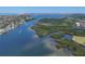 Picturesque aerial view of a waterway winding through lush mangroves near residential areas and the ocean at 1280 Dolphin Bay Way # 503, Sarasota, FL 34242