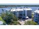 Aerial view of a condo complex near the water, boasting lush greenery and scenic surroundings at 1280 Dolphin Bay Way # 503, Sarasota, FL 34242