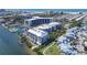 Aerial view of waterfront condos, marina, and community with lush landscaping and ocean views at 1280 Dolphin Bay Way # 503, Sarasota, FL 34242
