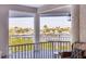 Balcony view showcasing neighborhood rooftops and mature palm trees at 1280 Dolphin Bay Way # 503, Sarasota, FL 34242