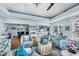 Comfortable seating in the community clubhouse, featuring a TV, bar, and access to the outside at 1280 Dolphin Bay Way # 503, Sarasota, FL 34242