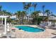 Inviting community pool with comfortable lounge chairs and beautifully landscaped surroundings at 1280 Dolphin Bay Way # 503, Sarasota, FL 34242