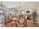 Spacious open-concept with living, dining, and balcony access, mirrored wall, and hardwood flooring at 1280 Dolphin Bay Way # 503, Sarasota, FL 34242