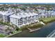 Beautiful waterfront condo featuring lush landscaping, a private dock, and coastal views at 1280 Dolphin Bay Way # 503, Sarasota, FL 34242