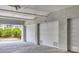 Garage space featuring numbered parking spots and visible lush greenery outside at 1280 Dolphin Bay Way # 503, Sarasota, FL 34242