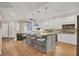 Modern kitchen with large island, pendant lighting, bar seating, and stainless steel appliances at 1280 Dolphin Bay Way # 503, Sarasota, FL 34242