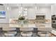 Kitchen island with decorative lighting, granite countertop, and bar seating at 1280 Dolphin Bay Way # 503, Sarasota, FL 34242