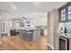 Open kitchen and living area with a large island with bar seating, and a custom bar with a wine fridge at 1280 Dolphin Bay Way # 503, Sarasota, FL 34242