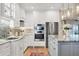 Bright kitchen featuring stainless steel appliances, granite countertops, and custom white cabinetry at 1280 Dolphin Bay Way # 503, Sarasota, FL 34242