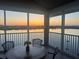 Relaxing lanai with sunset views, table, and chairs at 1280 Dolphin Bay Way # 503, Sarasota, FL 34242