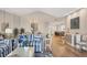 Inviting living area featuring hardwood floors and comfortable seating, flowing into the kitchen and dining area at 1280 Dolphin Bay Way # 503, Sarasota, FL 34242