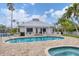 Community pool and clubhouse with lounge seating and nearby spa at 1280 Dolphin Bay Way # 503, Sarasota, FL 34242