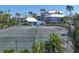 Well-maintained community tennis courts surrounded by lush tropical landscaping and nearby buildings at 1280 Dolphin Bay Way # 503, Sarasota, FL 34242