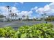 Community tennis courts with lush landscaping, providing a serene recreational experience at 1280 Dolphin Bay Way # 503, Sarasota, FL 34242