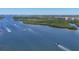Breathtaking water view showcasing boat activity amidst lush vegetation and a clear sky at 1280 Dolphin Bay Way # 503, Sarasota, FL 34242
