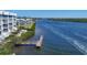 Scenic view of waterfront condos alongside a picturesque channel with a private wooden dock at 1280 Dolphin Bay Way # 503, Sarasota, FL 34242