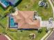 Overhead view of home's roof, screened pool, and landscaped yard with a circular driveway at 12830 24Th Street E Cir, Parrish, FL 34219