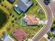 Overhead view of a neighborhood with manicured lawns, mature trees and community pool, and green spaces at 12830 24Th Street E Cir, Parrish, FL 34219