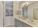 Bathroom vanity with double sinks, gray cabinets, and a walk-in shower at 12830 24Th Street E Cir, Parrish, FL 34219