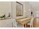 Dining area with a rustic wooden table, accent mirror, and built-in display cabinet at 12830 24Th Street E Cir, Parrish, FL 34219