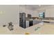 An updated kitchen features stainless steel appliances, light countertops, and a stylish backsplash design at 12830 24Th Street E Cir, Parrish, FL 34219