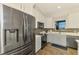 Well-lit kitchen featuring stainless steel appliances, two-tone cabinets, and a decorative window valance at 12830 24Th Street E Cir, Parrish, FL 34219