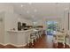 Open-concept kitchen featuring white cabinets, stainless steel appliances, and a breakfast bar at 12830 24Th Street E Cir, Parrish, FL 34219