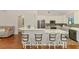 Kitchen featuring a wraparound breakfast bar with modern white cabinets and stainless appliances at 12830 24Th Street E Cir, Parrish, FL 34219