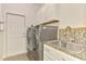 Laundry room featuring a sink and a gray front-load washer and dryer at 12830 24Th Street E Cir, Parrish, FL 34219