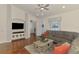 Open living area with a large sectional, entertainment center, and wood flooring at 12830 24Th Street E Cir, Parrish, FL 34219