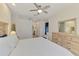 Primary bedroom with a king bed, light wood furniture, and access to an ensuite bathroom at 12830 24Th Street E Cir, Parrish, FL 34219