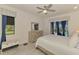 Comfortable primary bedroom with light wood furnishings and direct access to the outdoor pool area at 12830 24Th Street E Cir, Parrish, FL 34219