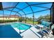 Sparkling pool with a screened enclosure and beautiful views of the lake and manicured lawn at 12830 24Th Street E Cir, Parrish, FL 34219