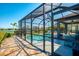 Home featuring a screened lanai, pool, lake view, and lush landscaping for luxurious outdoor living at 12830 24Th Street E Cir, Parrish, FL 34219