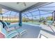 Screened-in pool and patio area with clear views of the lake, lush landscaping, and comfortable seating at 12830 24Th Street E Cir, Parrish, FL 34219